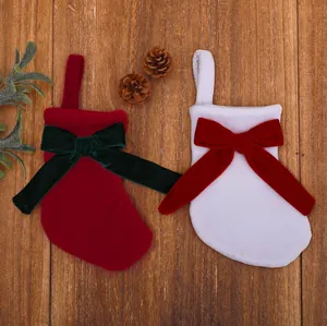 Detalle de calcetines de Navidad de terciopelo rojo y blanco con lazos decorativos
