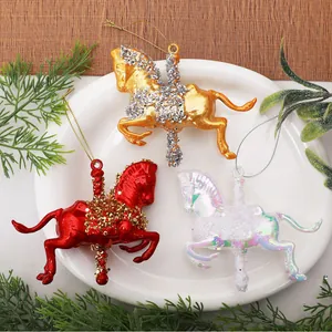 Detailed view of three colorful carousel horse Christmas tree ornaments arranged on a plate