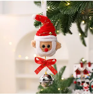 Close-up of a handmade pipe cleaner Santa ornament with a silver bell and ribbon