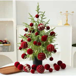 Detail of PE desktop Christmas tree set with red velvet ornaments for holiday decor