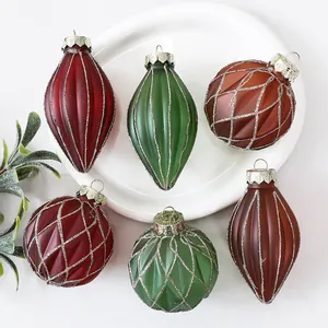 Close-up of hand-painted Christmas ornaments in assorted teardrop and round shapes