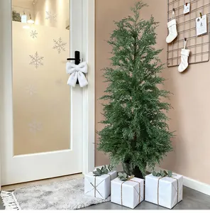 Realistic artificial arborvitae Christmas tree in a warm indoor holiday setting