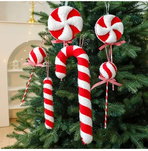 Red and white striped foam candy cane and lollipop ornaments on a green Christmas tree