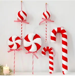 Detailed view of festive red and white striped candy cane and lollipop ornaments with bows
