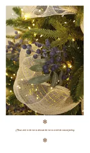 Close-up of artificial blueberry branches on a decorated Christmas tree with lights.