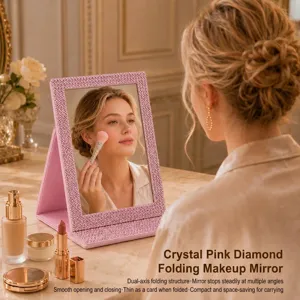 Close-up detail of a pink rhinestone folding makeup mirror in a vanity lifestyle scene