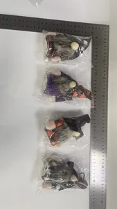 Dimensions of four Halloween light-up gnome dolls measured with a stainless steel ruler.