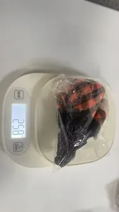 Detailed view of a Halloween light-up gnome plush weighed at 25.8g on a digital scale.