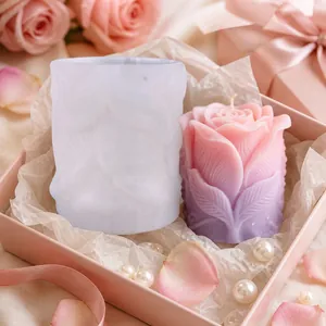 Rose flower silicone mold for DIY candle making with finished gradient candle in box.