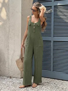 Full body view of a stylish green textured backless wide-leg jumpsuit on a model.