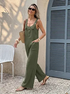 Fashionable woman wearing a casual green textured strap jumpsuit walking outdoors.