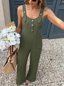 Close-up detail of an olive green textured summer jumpsuit with wooden buttons and pockets