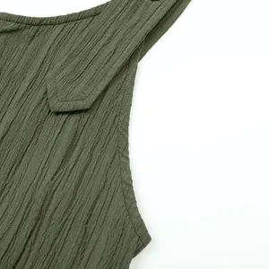Close-up of olive green crinkle textured fabric on women's suspender jumpsuit