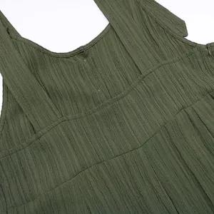 Close-up detail of olive green textured fabric on women's loose suspender jumpsuit