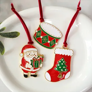 Set of three festive Christmas alloy ornaments featuring Santa, a stocking, and a drum