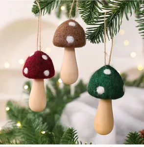 Detailed view of handmade wool felt mushroom ornaments hanging on Christmas tree