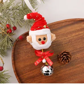Detailed shot of handmade pipe cleaner Santa Claus ornament with bell and red ribbon