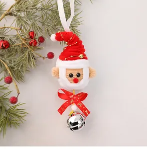 Detail of handmade Santa Claus Christmas tree ornament with plush texture and silver bell.