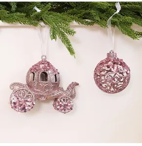 Detail of sparkly pink glitter pumpkin carriage and sequin ball Christmas tree ornaments