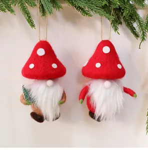 Detailed close-up of handmade wool felt Christmas gnome ornaments featuring red mushroom hats