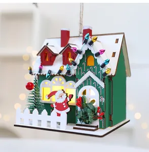 Detailed macro shot of a wooden Christmas house with LED lights and Santa Claus