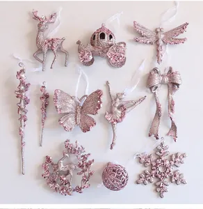Collection of pink glittery acrylic Christmas ornaments in various festive shapes