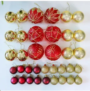 Detail of red and gold Christmas ornament balls with glitter and patterned designs.