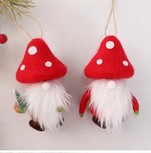 Detail of two handmade wool felt mushroom gnomes with white beards and hanging ropes.