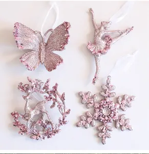 Detail of pink glittery Christmas ornaments featuring butterfly, ballerina, and snowflake shapes.