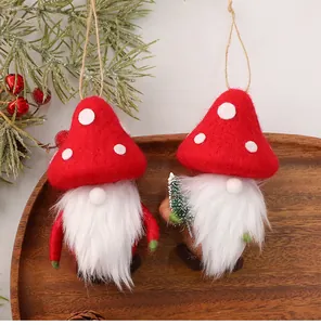 Close-up of wool felt Christmas gnomes with red mushroom hats on a wooden tray