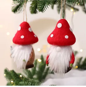 Detailed view of handmade wool felt gnomes with red mushroom hats on a Christmas tree