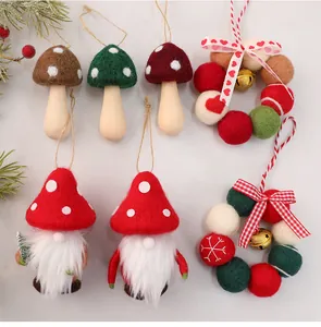 Detailed view of handmade wool felt Christmas gnome and mushroom tree ornaments