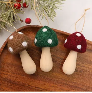 Detail view of handmade wool felt mushroom ornaments with wooden stems for Christmas