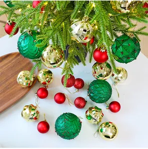 Detail view of red, green and gold festive Christmas ornaments on a desktop tree