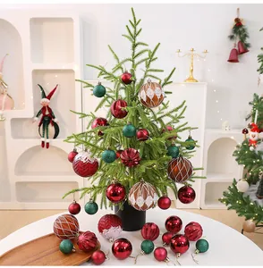 Desktop PE Christmas tree decorated with festive red green and brown ornaments