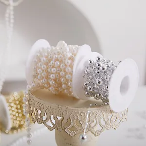Elegantly wound white and silver pearl bead chain spools for DIY Christmas decor