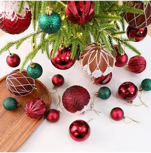 Detail showing assorted red and green textured Christmas ball ornaments on a mini PE tree