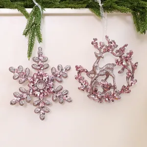 Pink glittery snowflake and reindeer Christmas tree hanging ornaments for holiday decor