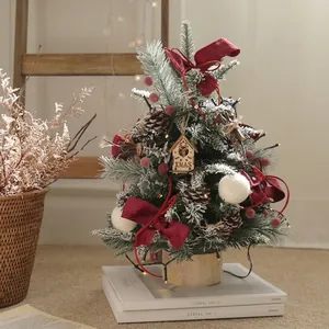 Elegant DIY desktop mini Christmas tree decorated with red berries and velvet bows