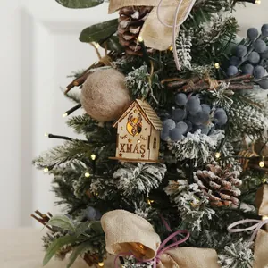 Miniature tabletop Christmas tree set with berries, pinecones and warm LED lights