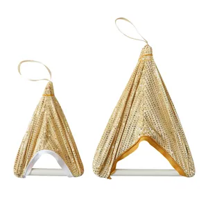 Detail of two gold sequined triangle Christmas ornaments on white background