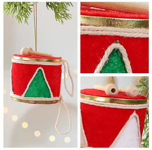 Détail de suspensions de Noël en feutrine rouge et verte en forme de tambour avec bâtons