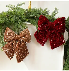 Detailed view of festive red and gold sequin bow ornaments for holiday Christmas decor.