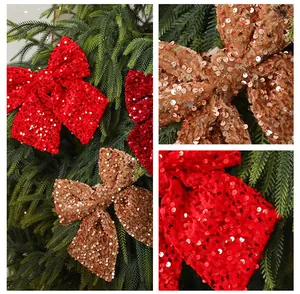 Macro view of sparkly red and gold sequined Christmas bows for festive tree decoration.