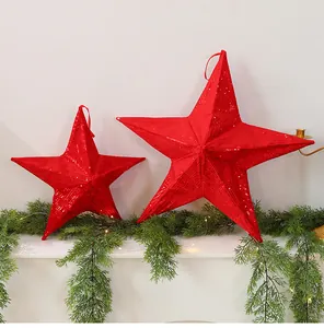 Close-up of red sequined folding stars as festive Christmas mantle decorations
