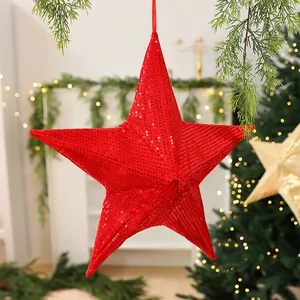 Close-up of a vibrant red sequined five-pointed star Christmas tree hanging ornament.
