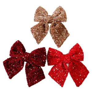 Decorative set of three glittery sequined Christmas bows in gold maroon and bright red