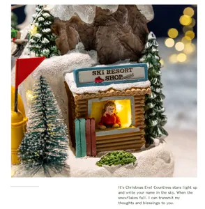 Detailed view of miniature ski resort shop cabin in glowing Christmas musical box