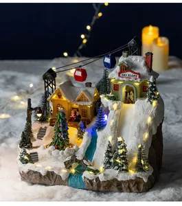 Detailed view of a light-up Christmas musical box with ski slope village scene and cable cars