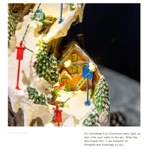 Detailed close-up of a lit-up Christmas village musical box with snowy house and skiers